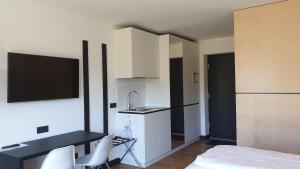 a room with a kitchen with a sink and a bed at AM Hotel by WMM Hotels in Ampfing