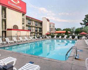 a pool at a hotel with chairs and a hotel at Econo Lodge Inn & Suites Rehoboth Beach in Rehoboth Beach