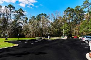 a parking lot with cars parked in it at Sleep Inn University in Tallahassee