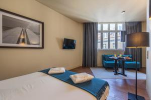 une chambre d'hôtel avec un lit et une salle à manger dans l'établissement 8 Building Apartments, à Lisbonne