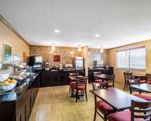 a restaurant with tables and chairs and a kitchen at Quality Inn Plant City - Lakeland in Plant City