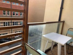 a balcony with a table and a window at Central Perks Apartment (sleeps 4) in Hull