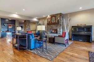 a living room with a fireplace and a blue couch at Comfort Inn & Suites in Blue Ridge