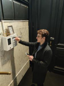 a man in a suit pointing at a microwave at B in Antwerp in Antwerp