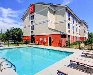 a hotel with a swimming pool in front of a building at Econo Lodge Inn & Suites Douglasville in Douglasville