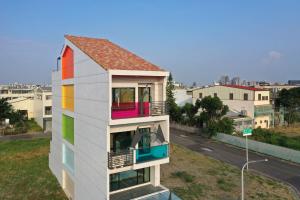 a house with rainbow windows and a street at Tainan Lio Kid Family Homestay in Tainan