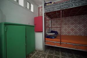 a room with two bunk beds and a green cabinet at White And Blue in Essaouira