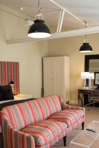 a living room with a couch and a table at Milsoms Kesgrave Hall in Ipswich