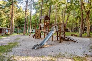 a playground in a park with a slide at Feriendorf Fynnus in Dranske