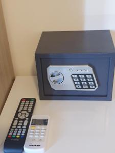 a box with two remotes and a remote control at Athens Center Solomou rooms in Athens