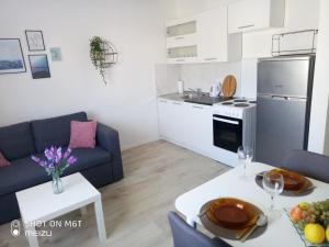 a kitchen and a living room with a couch and a table at Apartmani Darko in Međugorje