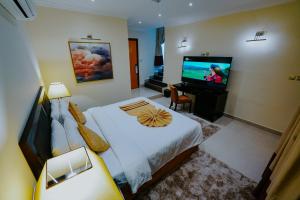 a bedroom with a bed and a flat screen tv at Villaggio Hotel Abu Dhabi in Abu Dhabi