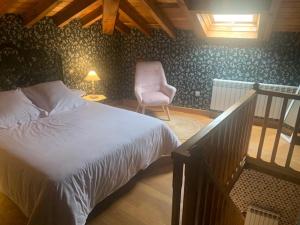 a bedroom with a bed and a chair in a room at Palacio de Arce in Puente Arce