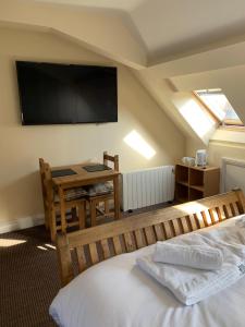 a room with a bed and a television on the wall at Castle house in Knaresborough