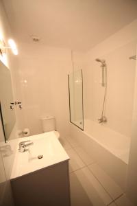 a white bathroom with a sink and a shower at Aphentrika Apartments in Protaras