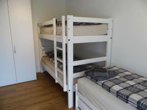 a room with two bunk beds and a bed at Apartment Titliszentrum 2 by Interhome in Engelberg
