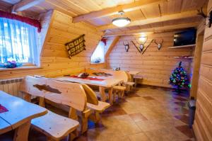 a dining room with tables and a christmas tree in it at Willa Stachowiec in Biały Dunajec