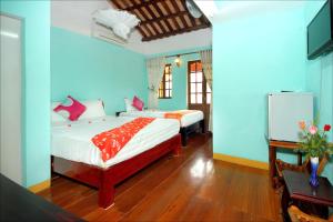 Кровать или кровати в номере Nha Lan Homestay
