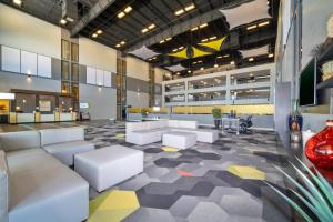 a lobby with couches and tables in a building at Holiday Inn Morgantown - Reading Area, an IHG Hotel in New Morgan