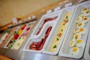 a display case with eggs and other food items at Hotel Akademie in Chocerady