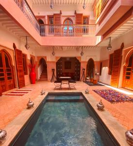 an indoor swimming pool in a house with a staircase at Riad Mazaya in Marrakesh