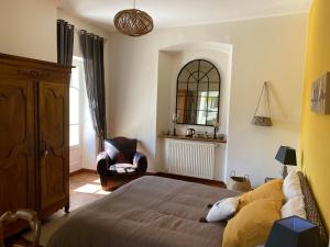 a bedroom with a bed with a teddy bear laying on it at Le Clos St Georges in Entraygues-sur-Truyère