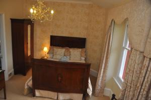 
a bedroom with a bed and a dresser at Bank House B and B in Penrith

