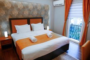 Postel nebo postele na pokoji v ubytování Umut Apartments