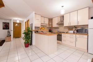 a kitchen with white cabinets and a counter top at Au Cocon des Cigognes in Sigolsheim