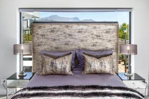 Un dormitorio con una cama grande con dos lámparas. en Villa de luxe, en Franschhoek