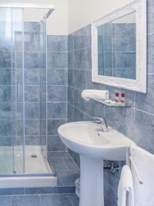 a bathroom with a sink and a shower at Grand Canal Suite by Wonderful Italy in Venice