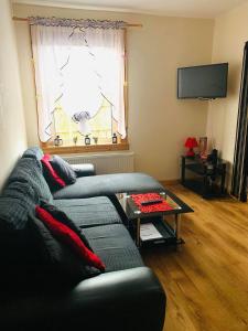 a living room with a couch and a table at Private Apartment in Dumfries