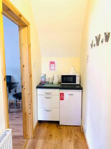 a kitchen with a white refrigerator and a microwave at Private Apartment in Dumfries