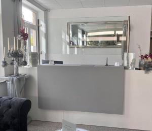 a white counter in a room with a mirror at Hotel Mythos "Apartments" in Markgröningen
