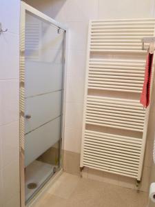 a shower with a glass door in a bathroom at B&B Casa Santina in Bologna