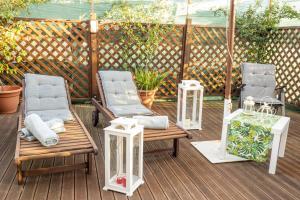 a group of chairs sitting on a deck at La Stagione dell'Arte B&B in Stiava