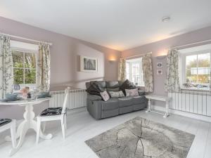 a living room with a couch and a table at The Forge in Morpeth