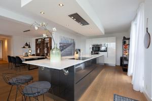
a kitchen with a table and chairs and a refrigerator at BizStay Harbour I Scheveningen Apartments in Scheveningen
