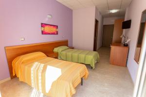 A bed or beds in a room at Il Viandante Catenanuova