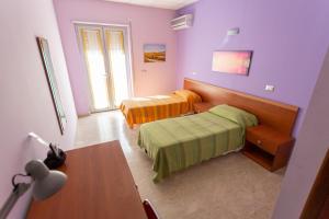 A bed or beds in a room at Il Viandante Catenanuova