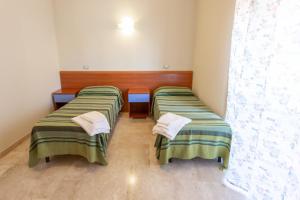 A bed or beds in a room at Il Viandante Catenanuova