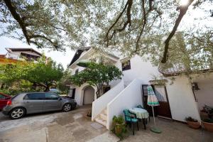 a house with a car parked in front of it at Apartman Jadranka in Zadar