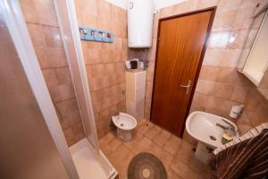 a small bathroom with a toilet and a sink at Apartman Jadranka in Zadar +25 photos