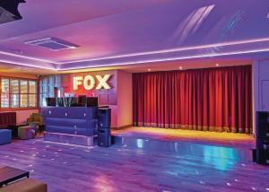 a dance floor with a fox sign in a room at Foxhunter Park in Minster