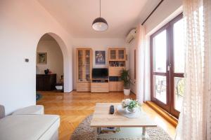 a living room with a couch and a table at Apartman Jadranka in Zadar