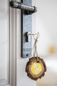 a piece of wood ornament hanging on a door at Blossom Hill Apartments in Łęcze
