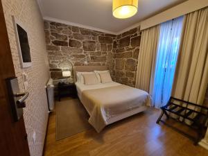 Säng eller sängar i ett rum på Quinta de Santo Estêvão Hotel Rural