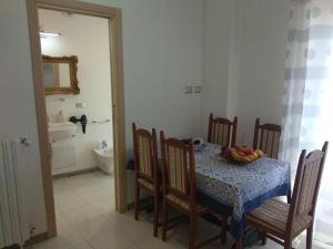 a dining room with a table with a bowl of fruit on it at PEDRA HOUSE in Catania