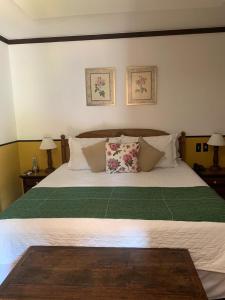 Cama ou camas em um quarto em Hotel Capim Limão Itaipava