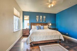 a blue bedroom with a bed and a blue wall at Waterfront Nevada Home with Balcony and Private Dock! in Sparks